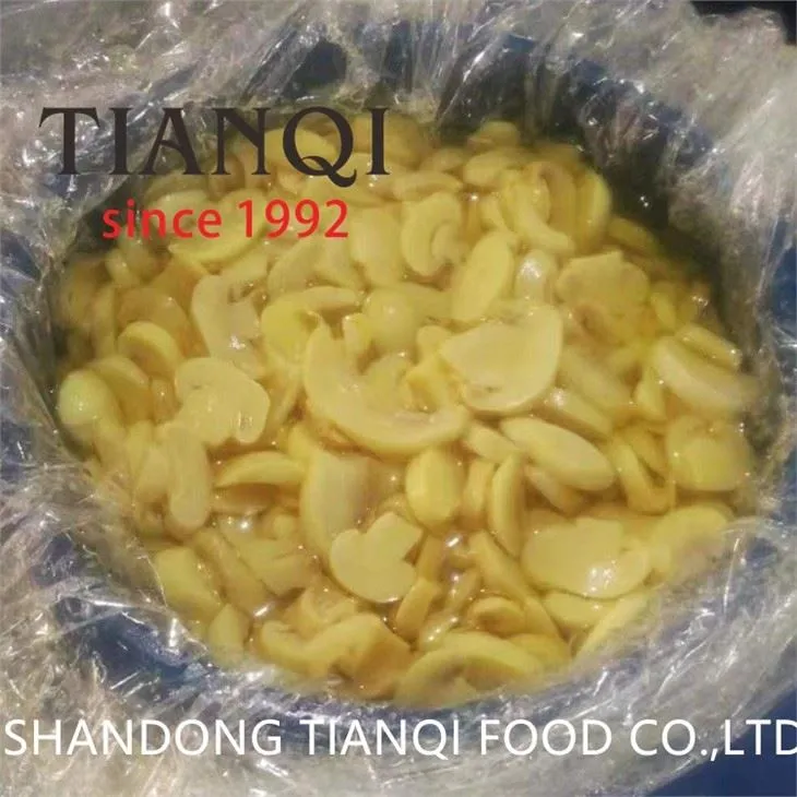 Edible white champignon mushroom in brine in big drum